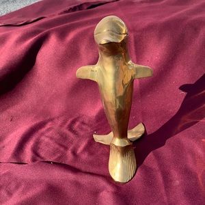 Decorative brass dolphin sculpture.
